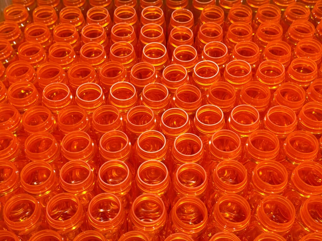 A group of pharmaceutical bottles stacked in a box.